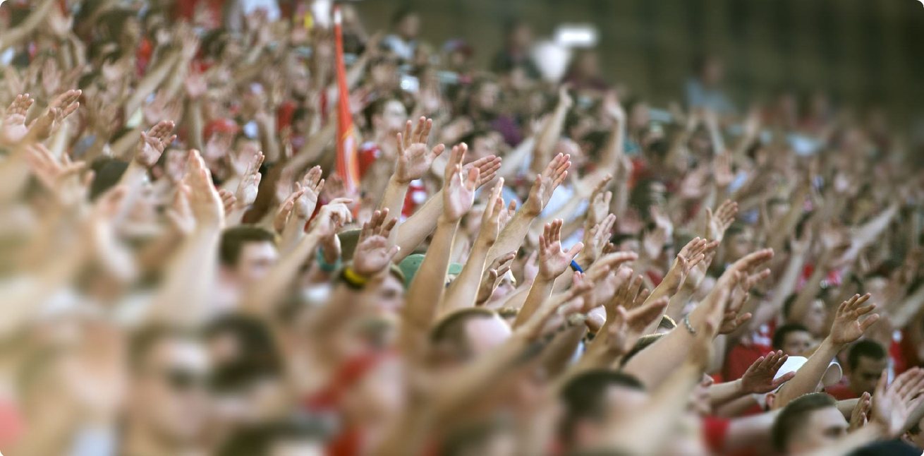 Seminoles fans with hands raised in the stands